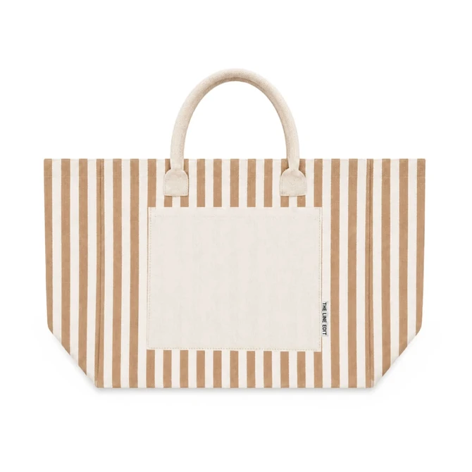 A large tote bag featuring horizontal stripes in beige and cream, with a solid pocket and handles.