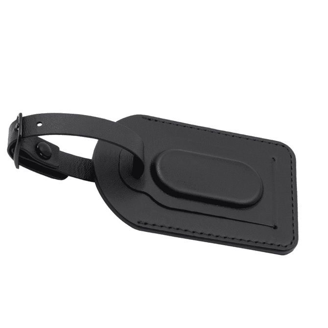 A black luggage tag with a textured surface and a sturdy attachment strap. It features a smooth, raised centre.