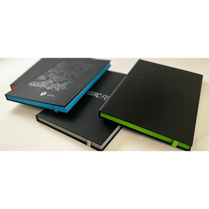 A set of Colour Pop JournalBooks in black, blue, and green, featuring varying designs and a logo on one.