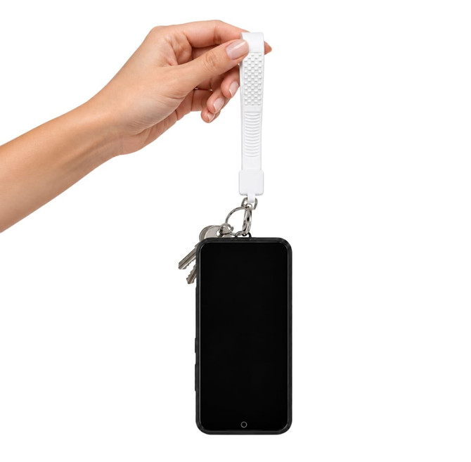 A white wrist tactile phone holder keytag is being held, attached to a smartphone and keys.