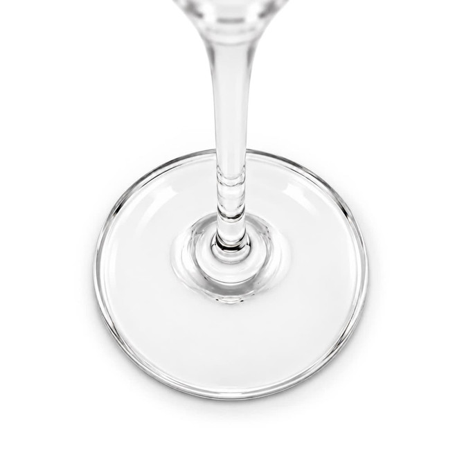 A clear glass flute features an elegant design with a smooth, round base and a slender stem.
