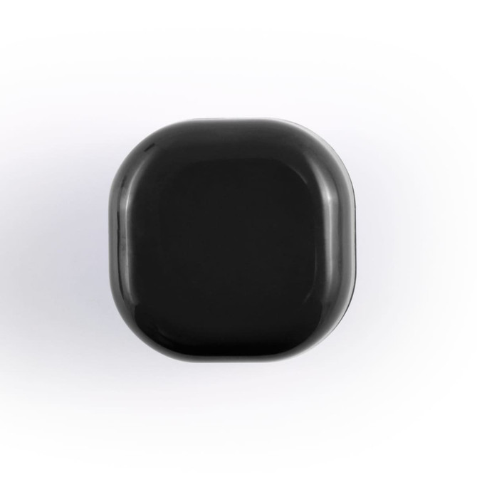 A black cube lip balm with rounded edges, featuring a branding logo on the surface.