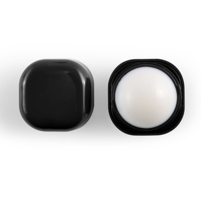A black cube-shaped lip balm container with a white balm center, featuring a sleek design and logo.