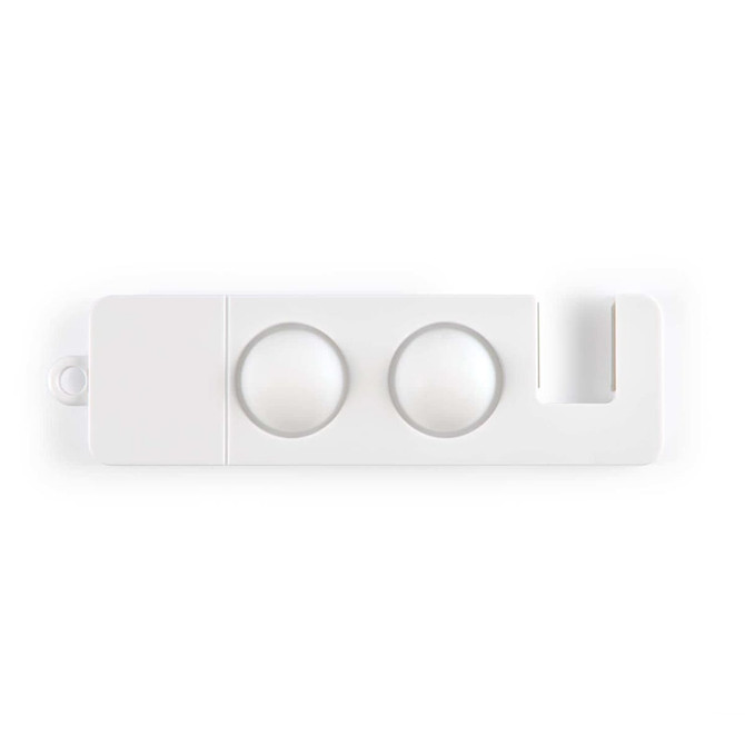 A white phone stand featuring two circular depressions and a slot for a device.