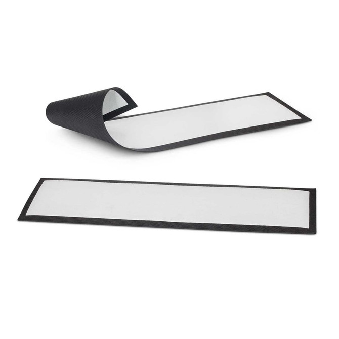 A black bar runner with a textured surface, featuring two mats, one rolled and one flat.