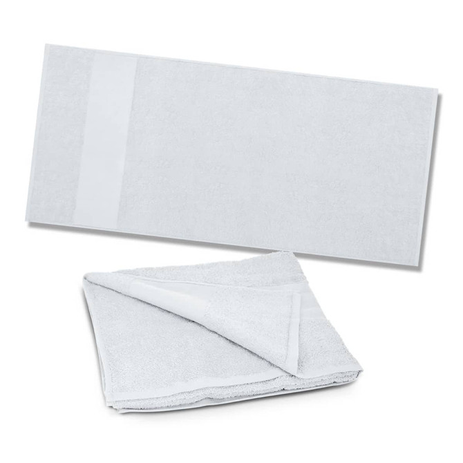 A soft, light grey beach towel folded in half, featuring a subtle logo on one side.