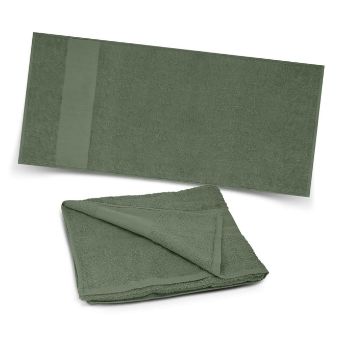 A green Dune Beach Towel displayed unfolded and folded, highlighting its soft texture and simple design.