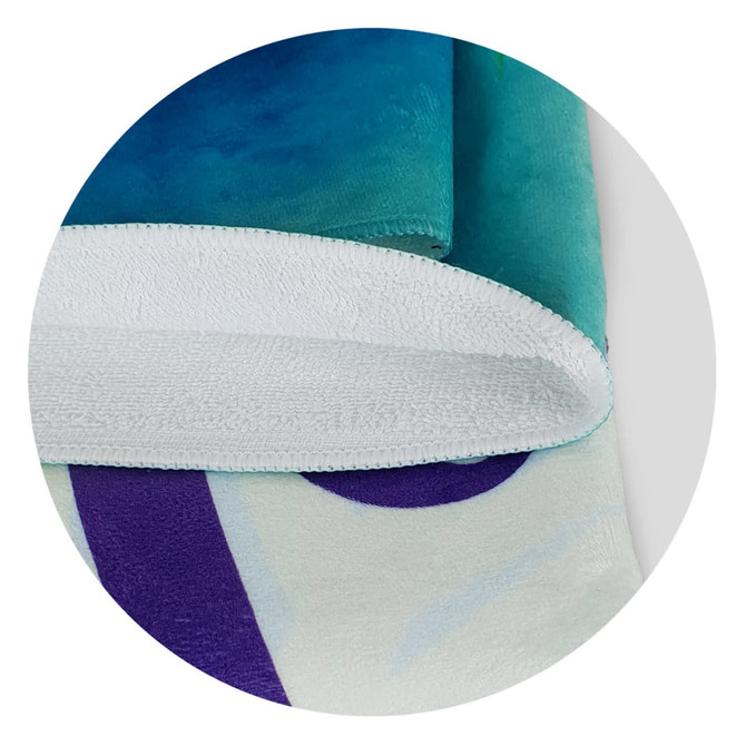A full-colour beach towel featuring vibrant blue, green, and purple designs, with a white terry backing and a logo.