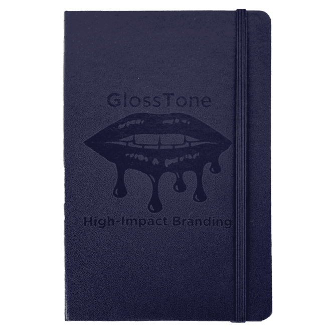 A navy blue journal with a textured cover and an elastic closure. It features a branding logo on the front.