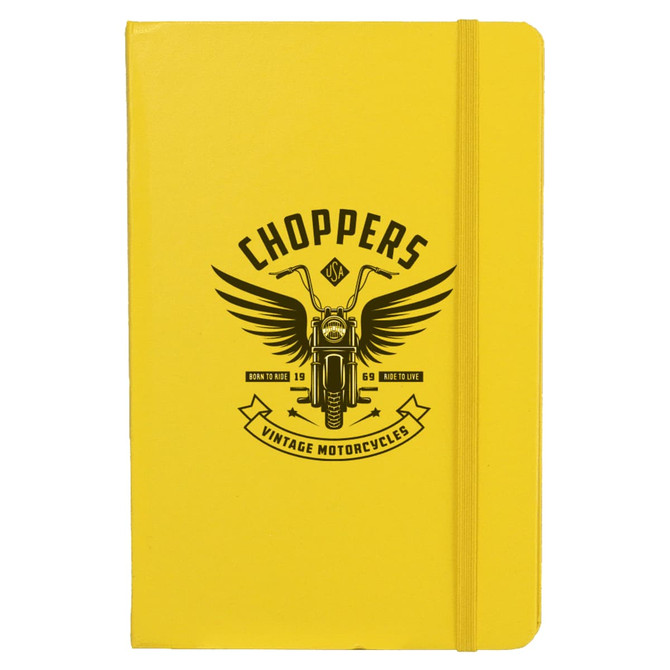 A yellow journal with a motorcycle graphic and an emblem featuring wings and text on the cover.