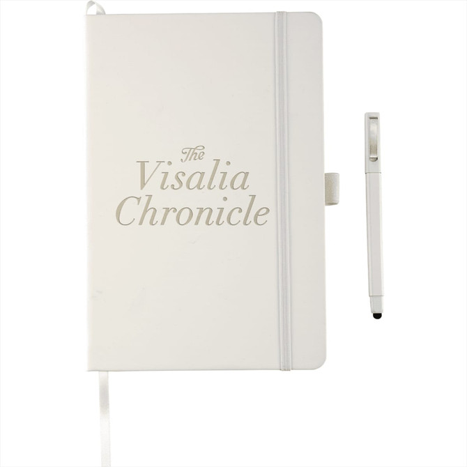 A white hardbound journal with a pen, featuring a logo and a ribbon bookmark.