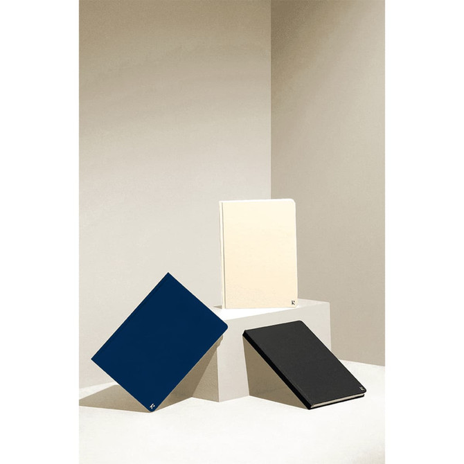 A set of three hardcover notebooks in navy, cream, and black, featuring a minimalist design and brand logo.