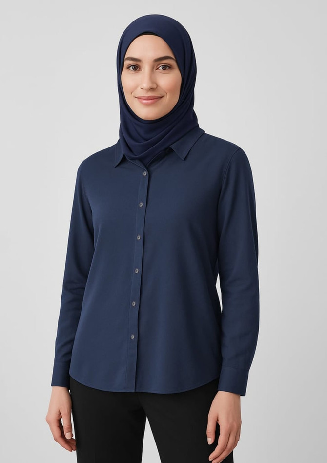 A women's navy hijab worn with a matching long-sleeve shirt, featuring a button-up design. The model has a neutral expression. A women's navy hijab worn with a matching long-sleeve shirt, featuring a button-up design. The model has a neutral expression.