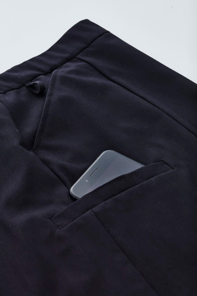 A black cargo skirt with a smartphone tucked into a side pocket. The fabric appears soft and comfortable.