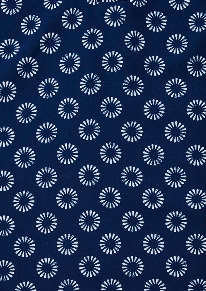 A navy tunic featuring a daisy print pattern in white. Includes a logo.