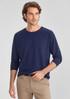 A navy long sleeve tee for men, featuring a relaxed fit and a logo. Paired with light-coloured pants.
