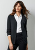 A woman models a dark grey cardigan, featuring a button front and ribbed cuffs, paired with a white shirt and black trousers.