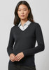 A women's Milano pullover in black, featuring a V-neck design and long sleeves, worn over a collared shirt.