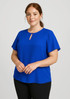 A blue short sleeve blouse with a keyhole detail, paired with black bottoms. It features a simple, elegant design and has branding. A blue short sleeve blouse with a keyhole detail, paired with black bottoms. It features a simple, elegant design and has branding.