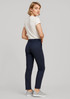 A pair of women's slim leg stretch chino pants in navy, styled with a fitted white t-shirt and grey shoes.
