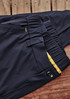 Lightweight men's outdoor cargo pants in black, featuring a button closure and elastic waistband, with a logo present.