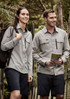 A light grey long sleeve button-up shirt is worn by a man and a woman outdoors, with a backpack and shorts.