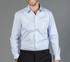 A button-up shirt in light blue with a subtle striped pattern, featuring a single chest pocket.