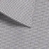 A button-up shirt featuring a grey puppytooth pattern with a crisp collar and a subtle texture.