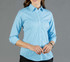 A button-up shirt in light blue gingham with long sleeves and a fitted design. The shirt has a logo on it.