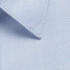 A light blue button-up shirt fabric close-up, featuring textured weave and neat collar detail.