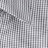 A close-up of fabric featuring a black and white check pattern, suitable for a button-up shirt.