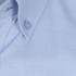 A light blue button-up shirt featuring a collar and a single button. The shirt has a logo on it.