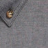 A close-up of a textured grey work shirt featuring a button and collar detail.