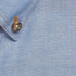 A blue work shirt featuring a buttoned collar and a textured fabric, with a logo on the side.