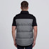 A puffa vest in grey and black with a branding logo, featuring a padded design and a collar.