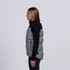 A grey and black puffa vest with a high collar, featuring a branding logo, viewed from the side.