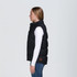 A black puffa vest with a high collar and side pockets, featuring a logo, displayed on a model.