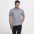 A grey polo shirt with contrasting black and white stripes on the collar and sleeves, featuring a logo.