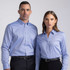 A women's button-up shirt in light blue with a collar and a logo. Paired with formal black trousers.