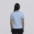 A light blue women's polo shirt featuring a collar and contrasting trim. The back view shows a logo on the upper neck area.