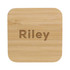 A bamboo wireless charger with a smooth, natural finish and rounded edges. It features a logo on the surface.