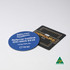 Two round and square coasters, one blue with a logo and contact details, and one black with text, featuring a logo.
