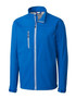 A blue Men's Clique Telemark softshell jacket featuring a zippered pocket and a high collar. It includes branding details.