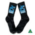 A pair of black sports socks featuring a blue shark logo and design.