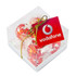 A clear cube filled with five red-wrapped Lindt chocolates, tied with a gold ribbon and featuring a tag.