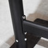 A close-up of a black metal crowd control barrier, featuring bolts and a sturdy base.
