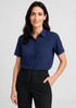 A short sleeve blouse in navy blue, featuring a button-up front and a collar, paired with black trousers. A short sleeve blouse in navy blue, featuring a button-up front and a collar, paired with black trousers.