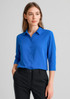 A vibrant blue 3/4 sleeve blouse with a collar and buttons, paired with black trousers.