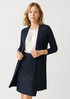A longline cardigan in navy blue, featuring a open front and long sleeves, paired with a white top and skirt. A longline cardigan in navy blue, featuring a open front and long sleeves, paired with a white top and skirt.