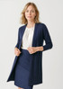 A longline cardigan in navy, featuring an open front and long sleeves, paired with a blouse and skirt.